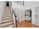 Entryway features wood floors, white walls, staircase, and views to the living room at 3511 Stone Cliff Way, Woodstock, GA 30189