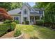 Charming two-story home featuring manicured landscaping, and a well-maintained lawn at 3511 Stone Cliff Way, Woodstock, GA 30189