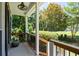 Covered front porch offers a cozy outdoor space with wood railings and manicured landscaping at 3511 Stone Cliff Way, Woodstock, GA 30189