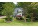 Beautiful home with mature trees and manicured landscaping surrounding the well-maintained lawn at 3511 Stone Cliff Way, Woodstock, GA 30189