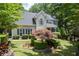 Charming home with manicured lawn, mature trees, and meticulously maintained landscaping at 3511 Stone Cliff Way, Woodstock, GA 30189