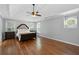 Well-lit main bedroom features hardwood flooring, tray ceiling, and abundant windows at 3511 Stone Cliff Way, Woodstock, GA 30189
