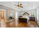 Spacious main bedroom with tray ceiling, hardwood flooring, and large dressing mirror at 3511 Stone Cliff Way, Woodstock, GA 30189