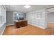 Home office with gray walls, wood floors, built-in shelving, and a large window at 3511 Stone Cliff Way, Woodstock, GA 30189