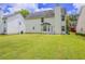 Spacious backyard with green grass and partial view of the back of the house at 4185 Post Oak Grv, Atlanta, GA 30349