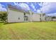 Large, grassy backyard with privacy and houses in the distance at 4185 Post Oak Grv, Atlanta, GA 30349