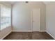 This carpeted bedroom features neutral paint, a window with blinds, and a closet at 4185 Post Oak Grv, Atlanta, GA 30349
