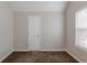 This is a bedroom with a closet and a window that lets in plenty of natural light at 4185 Post Oak Grv, Atlanta, GA 30349