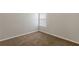 An empty bedroom showing neutral walls, carpet, a window and electrical outlets at 4185 Post Oak Grv, Atlanta, GA 30349