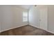 A well-lit bedroom features neutral walls, carpeting, and a window that streams in sunlight at 4185 Post Oak Grv, Atlanta, GA 30349