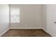 An empty bedroom with neutral walls, carpet, a window with blinds and a closet at 4185 Post Oak Grv, Atlanta, GA 30349