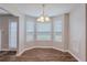 Bright dining area with wood floors, chandelier, and natural light streaming through the windows at 4185 Post Oak Grv, Atlanta, GA 30349