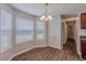 Cozy dining area featuring wood floors, a chandelier, and natural light from the windows at 4185 Post Oak Grv, Atlanta, GA 30349
