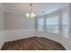 Bright dining area with wood floors, paneling, and a chandelier lighting at 4185 Post Oak Grv, Atlanta, GA 30349