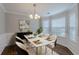 Elegant dining area with stylish chandelier, seating for six, and bay window, perfect for formal gatherings at 4185 Post Oak Grv, Atlanta, GA 30349