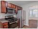 Functional kitchen with stainless steel appliances, and wooden cabinets, offering a practical cooking space at 4185 Post Oak Grv, Atlanta, GA 30349
