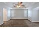 Large main bedroom featuring neutral walls, carpeted floors, and a tray ceiling at 4185 Post Oak Grv, Atlanta, GA 30349