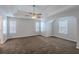 Spacious main bedroom with carpeted floors, a tray ceiling, and lots of natural light at 4185 Post Oak Grv, Atlanta, GA 30349