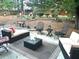 Backyard seating area with furniture and greenery at 912 Spring Vly, Woodstock, GA 30189