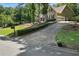 Traditional-style home with mature trees, long driveway, and attached garage at 912 Spring Vly, Woodstock, GA 30189