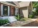 Charming front entrance with brick facade, painted steps, and decorative flowerbeds at 912 Spring Vly, Woodstock, GA 30189