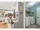 Kitchen with laundry room featuring front load washer and dryer, storage shelf, and utility sink at 912 Spring Vly, Woodstock, GA 30189