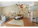 Open living room boasts vaulted ceiling, hardwood floors, and a staircase to upper level at 912 Spring Vly, Woodstock, GA 30189