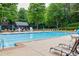 Community swimming pool with lounge chairs and umbrellas at 912 Spring Vly, Woodstock, GA 30189