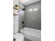 This bathroom offers a tub/shower, modern tile surround, and floating shelves at 941 Garibaldi Sw St, Atlanta, GA 30310