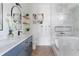 This bathroom offers double sinks, stone counters, modern fixtures, and a soaking tub at 941 Garibaldi Sw St, Atlanta, GA 30310