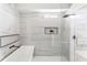 This bathroom is finished with modern tile, soaking tub and glass enclosed shower at 941 Garibaldi Sw St, Atlanta, GA 30310