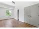 This bedroom offers a large window with wooded views, hardwood floors, and ample closet space at 941 Garibaldi Sw St, Atlanta, GA 30310