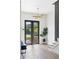 Bright entryway with wood floors, staircase, modern lighting and large black framed glass doors to the exterior at 941 Garibaldi Sw St, Atlanta, GA 30310