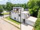 Modern home featuring clean white siding, black trim, multiple decks, and a spacious garage at 941 Garibaldi Sw St, Atlanta, GA 30310
