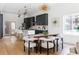 Modern kitchen and dining area with gray cabinets, white countertops, pendant lighting, and seating for six at 941 Garibaldi Sw St, Atlanta, GA 30310