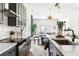 Bright kitchen featuring gray cabinets, a white backsplash, and stainless steel appliances, flowing into an open living space at 941 Garibaldi Sw St, Atlanta, GA 30310