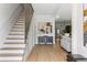 Open-concept living room with fireplace and shelving and hardwood floors throughout the property at 941 Garibaldi Sw St, Atlanta, GA 30310