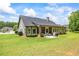 Beautiful backyard showcasing the home's screened-in porch and lush landscaping at 1524 Guthrie Crossing Dr, Loganville, GA 30052
