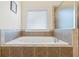 Inviting bathtub with tile surround and chrome faucet at 1524 Guthrie Crossing Dr, Loganville, GA 30052