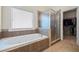 This stylish bathroom boasts a soaking tub, a separate shower, and plenty of natural light at 1524 Guthrie Crossing Dr, Loganville, GA 30052