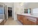 This bathroom features tile floors, a closet, a soaking tub, and and sinks at 1524 Guthrie Crossing Dr, Loganville, GA 30052