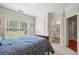 Comfortable bedroom features a window view, an ensuite bathroom, and a walk-in closet at 1524 Guthrie Crossing Dr, Loganville, GA 30052
