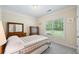Comfortable bedroom featuring carpet floors, and a window with a view of the backyard at 1524 Guthrie Crossing Dr, Loganville, GA 30052