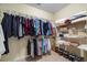 Walk in closet with built in shelving for clothing and shoes at 1524 Guthrie Crossing Dr, Loganville, GA 30052