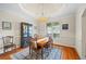 Elegant dining room boasts hardwood floors, crown molding, and a stylish chandelier at 1524 Guthrie Crossing Dr, Loganville, GA 30052