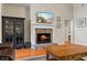Cozy fireplace with stone surround, mounted TV, cabinet, and hardwood floors create a warm ambiance at 1524 Guthrie Crossing Dr, Loganville, GA 30052