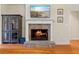 Inviting fireplace features stone surround, mounted TV, and adjacent cabinet for a comfortable living space at 1524 Guthrie Crossing Dr, Loganville, GA 30052