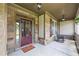 Charming front porch with stone accents, featuring a rocking chair and covered entryway at 1524 Guthrie Crossing Dr, Loganville, GA 30052