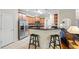 Open kitchen with stainless steel appliances, granite countertops, breakfast bar, and tile flooring at 1524 Guthrie Crossing Dr, Loganville, GA 30052
