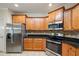 Modern kitchen with stainless steel appliances, tile backsplash and custom wood cabinets at 1524 Guthrie Crossing Dr, Loganville, GA 30052